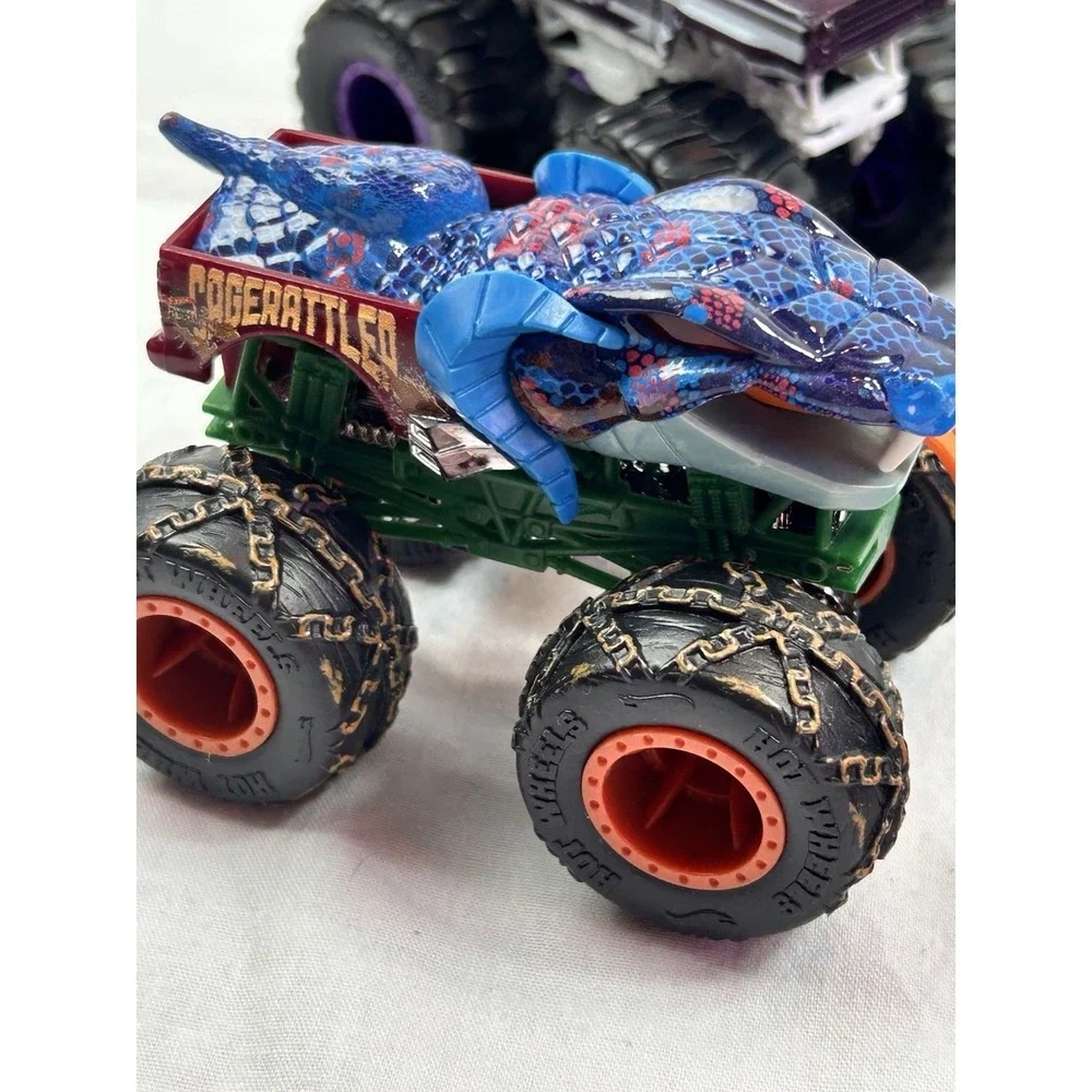 Lot Of 4 Diecast Monster Trucks 3 Hot wheels El Toro Grave Digger Rattlesnake